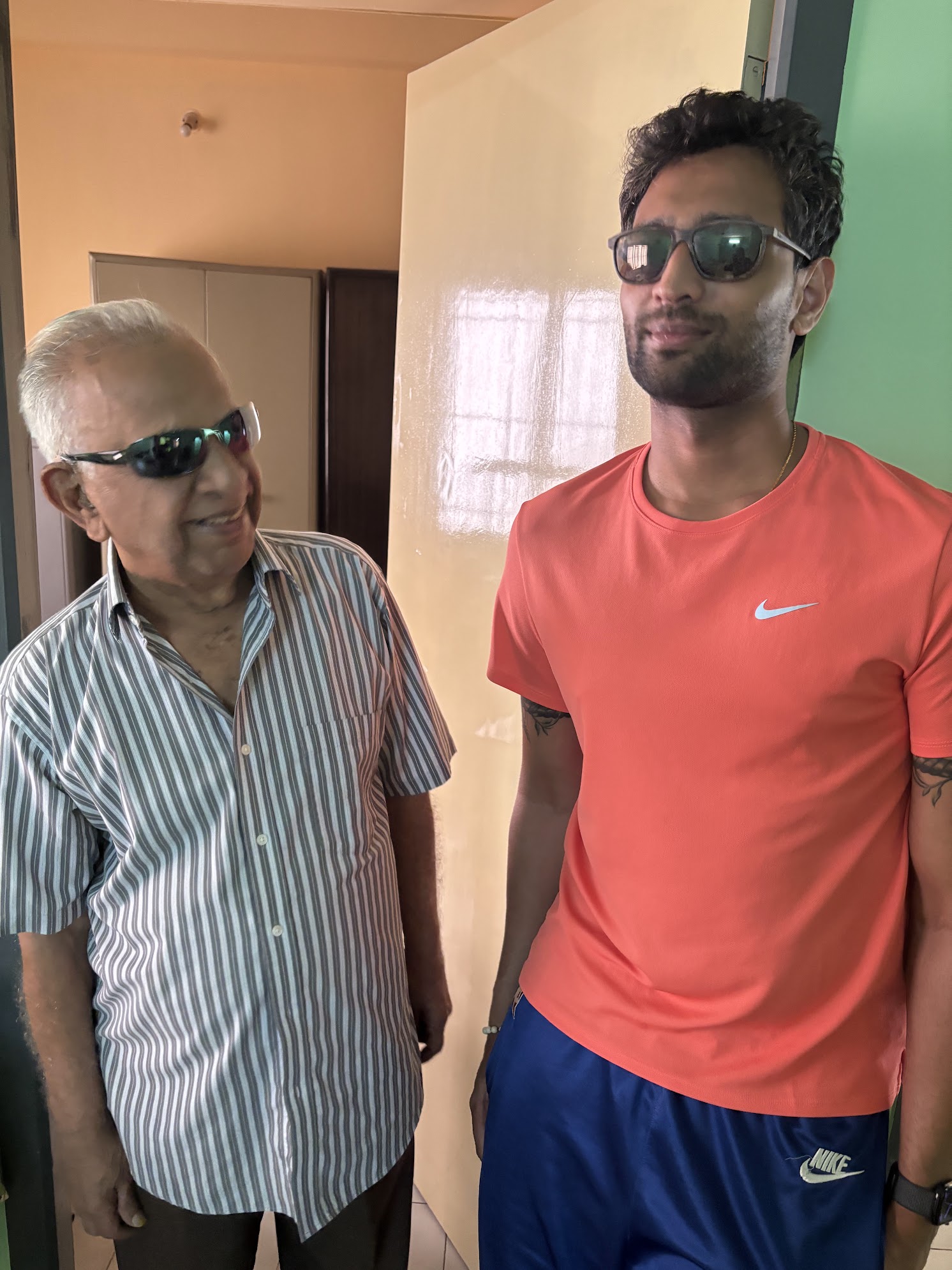 With grandfather, both wearing sunglasses